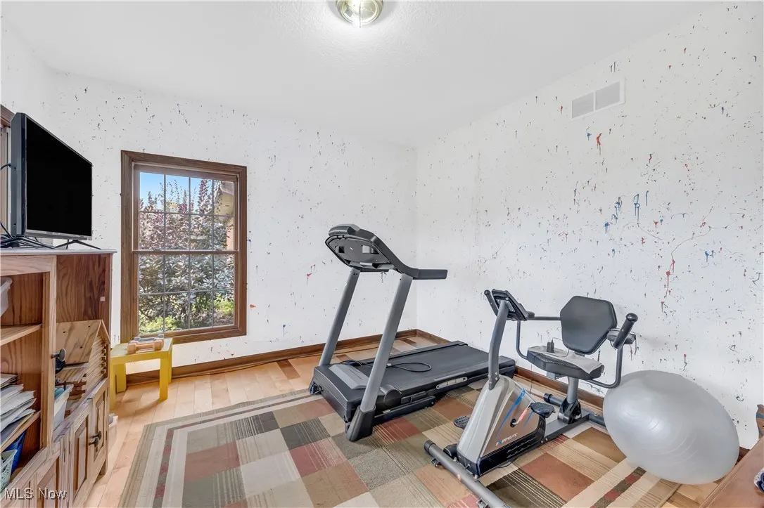 Workout area featuring light wood