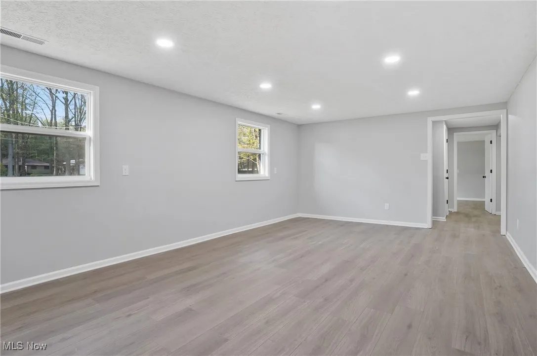 3740 Wilson Sharpsville Rd, Cortland, Ohio 44410 – Your dream home awaits! This stunning 5-bed, 3-bath single-family residence, completely renovated top-to-bottom, sits on a spacious 0.58-acre lot, blending luxury, functionality, and room to grow. Step into a bright, airy open-concept living space, perfect for modern living and effortless entertaining. The heart of the home is a gourmet kitchen featuring sleek Black Stainless Steel Samsung appliances, gorgeous Quartz Countertops, and an oversized island—ideal for meal prep, casual dining, or hosting. Enjoy abundant natural light through new windows and great installed lighting. Luxury LVT Shaw flooring flows seamlessly throughout, adding warmth and durability. Each of the three full bathrooms is beautifully updated with stylish finishes, offering a spa-like retreat.