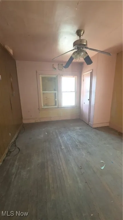 Empty room featuring wood-type flooring and a ceiling fan