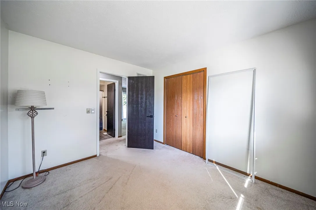 Unfurnished bedroom featuring a closet and carpet