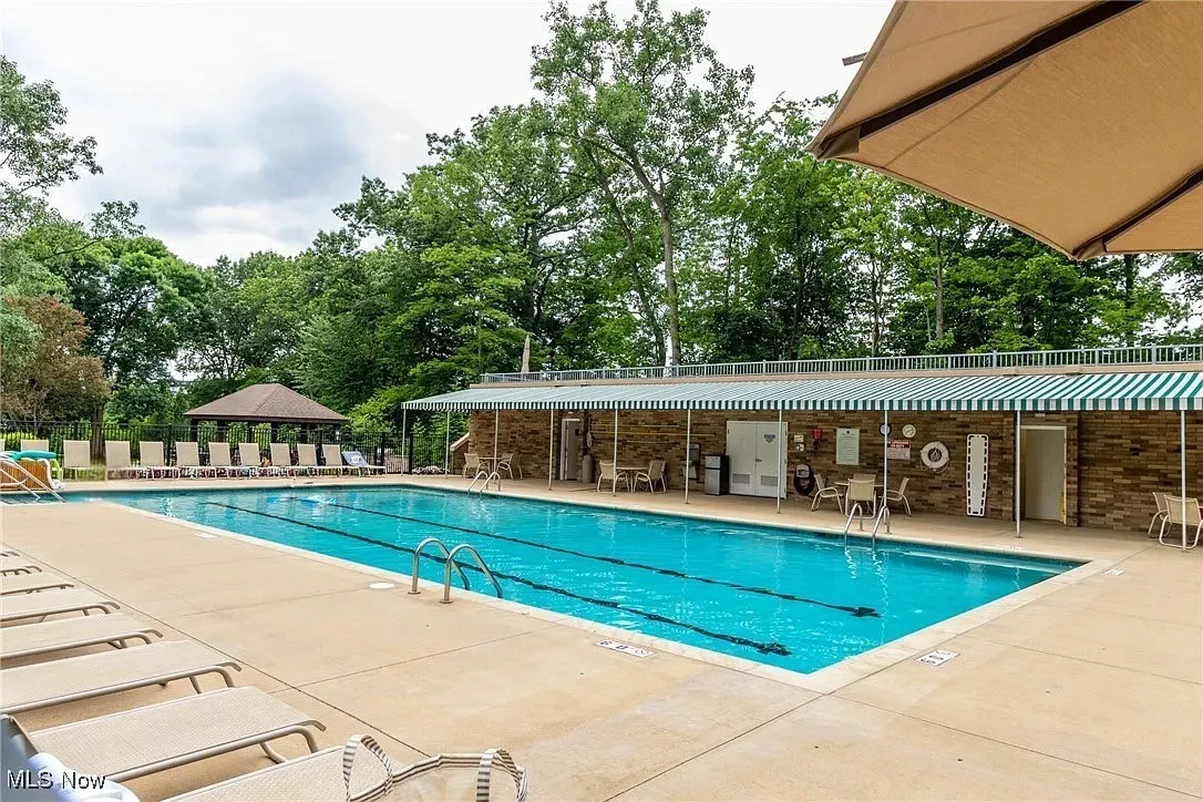 Community pool featuring a patio and a gazebo
