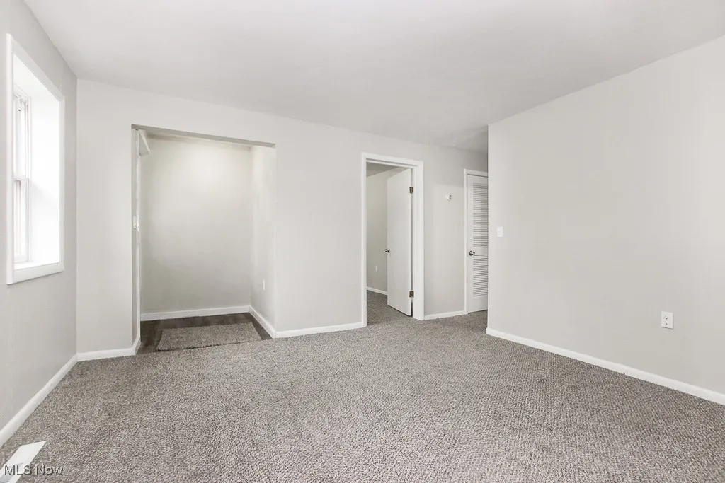 Living room with carpet flooring and baseboards