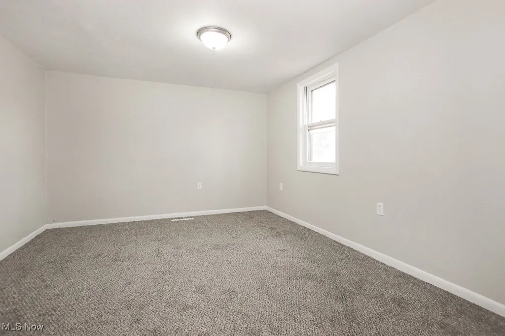 Empty room with baseboards and carpet flooring
