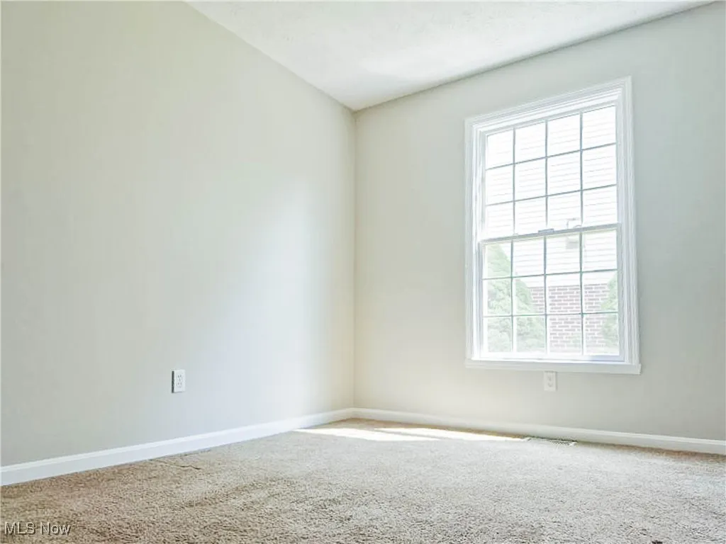 Empty room featuring carpet floors and baseboards