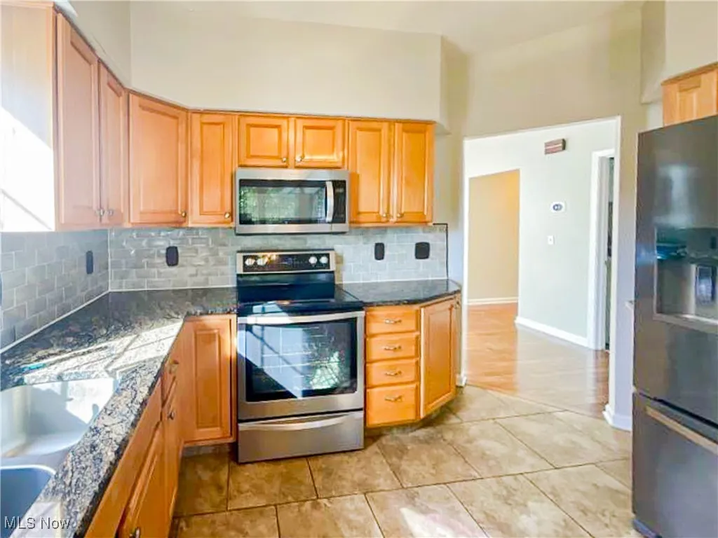 Kitchen featuring backsplash and granite countertops