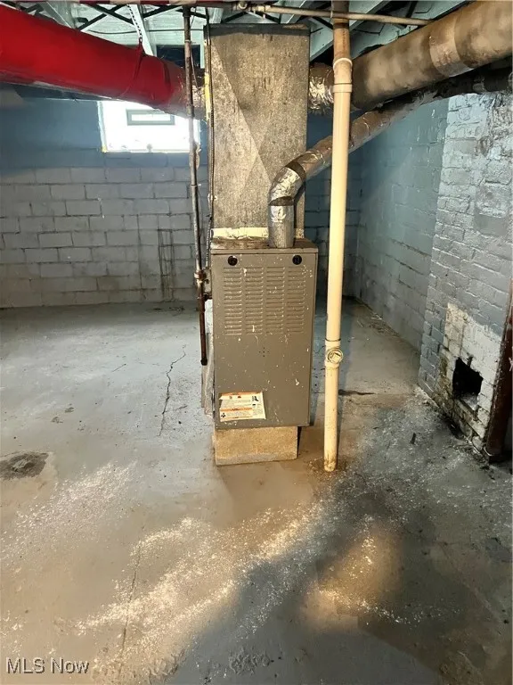 Basement featuring heating unit