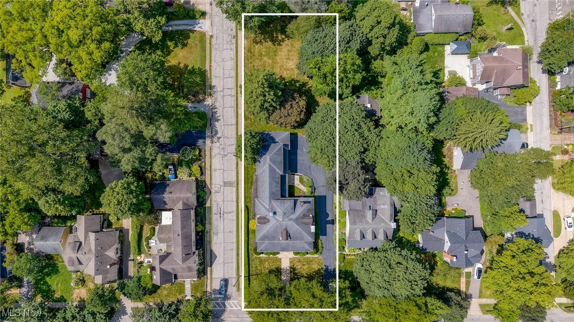 Aerial perspective of suburban area featuring property boundaries highlighted