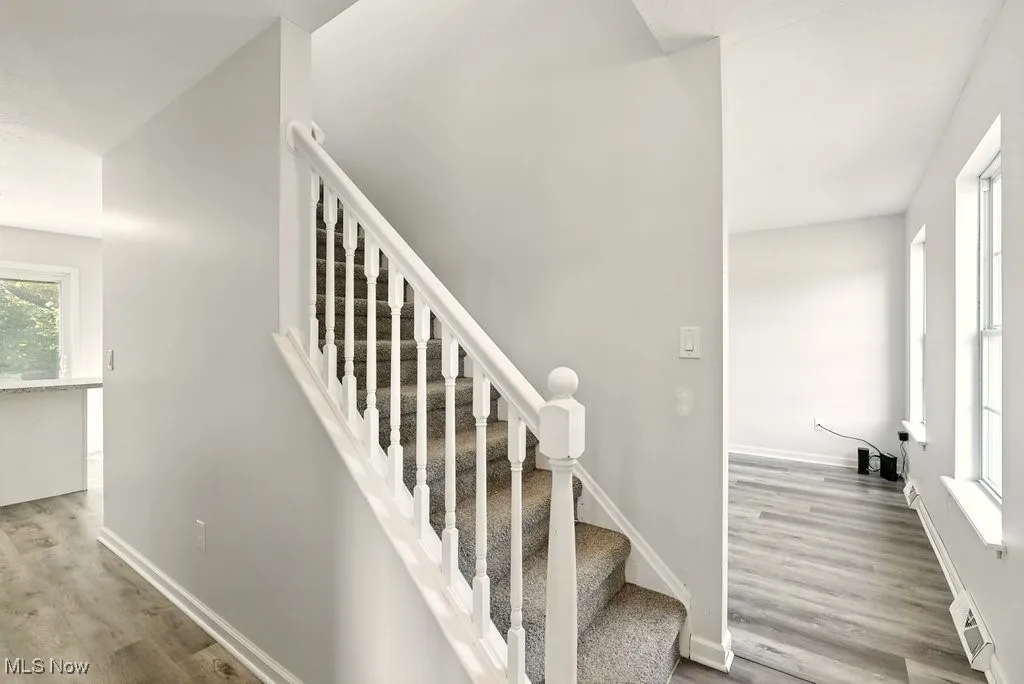 Staircase featuring wood finished floors