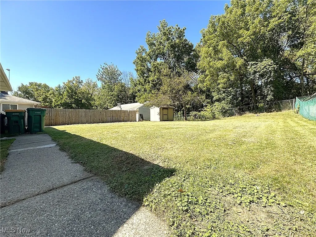 Fenced backyard with a shed
