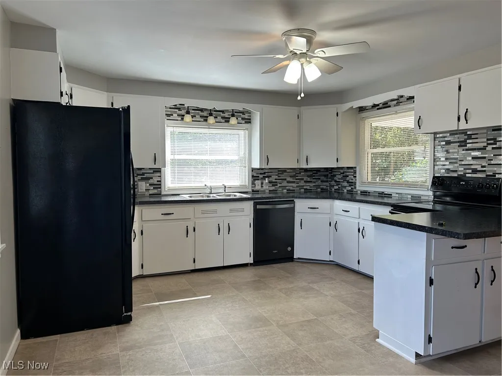 Kitchen featuring tasteful backsplash, stainless steel refrigerator, dishwashing machine, and range