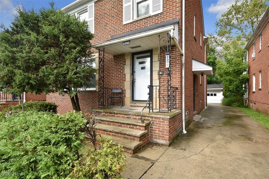 View of exterior entry with brick siding