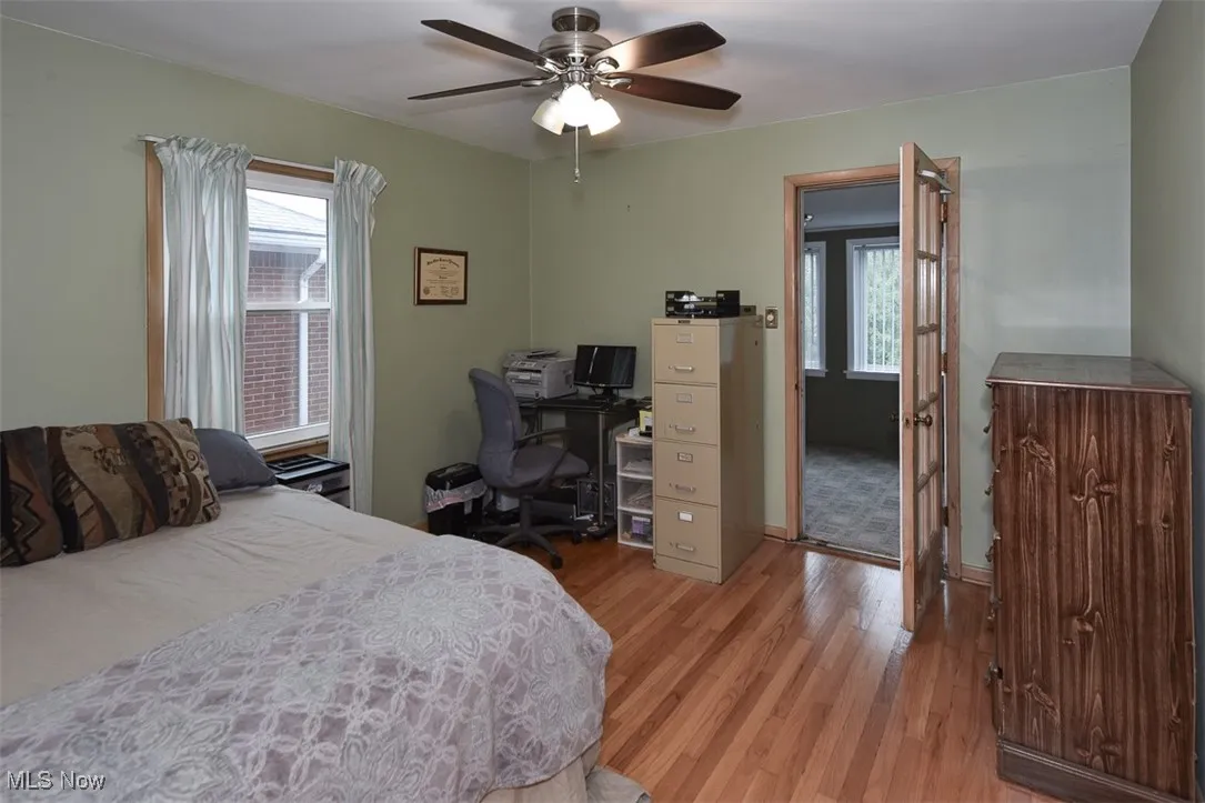 Bedroom with light wood finished floors and a ceiling fan