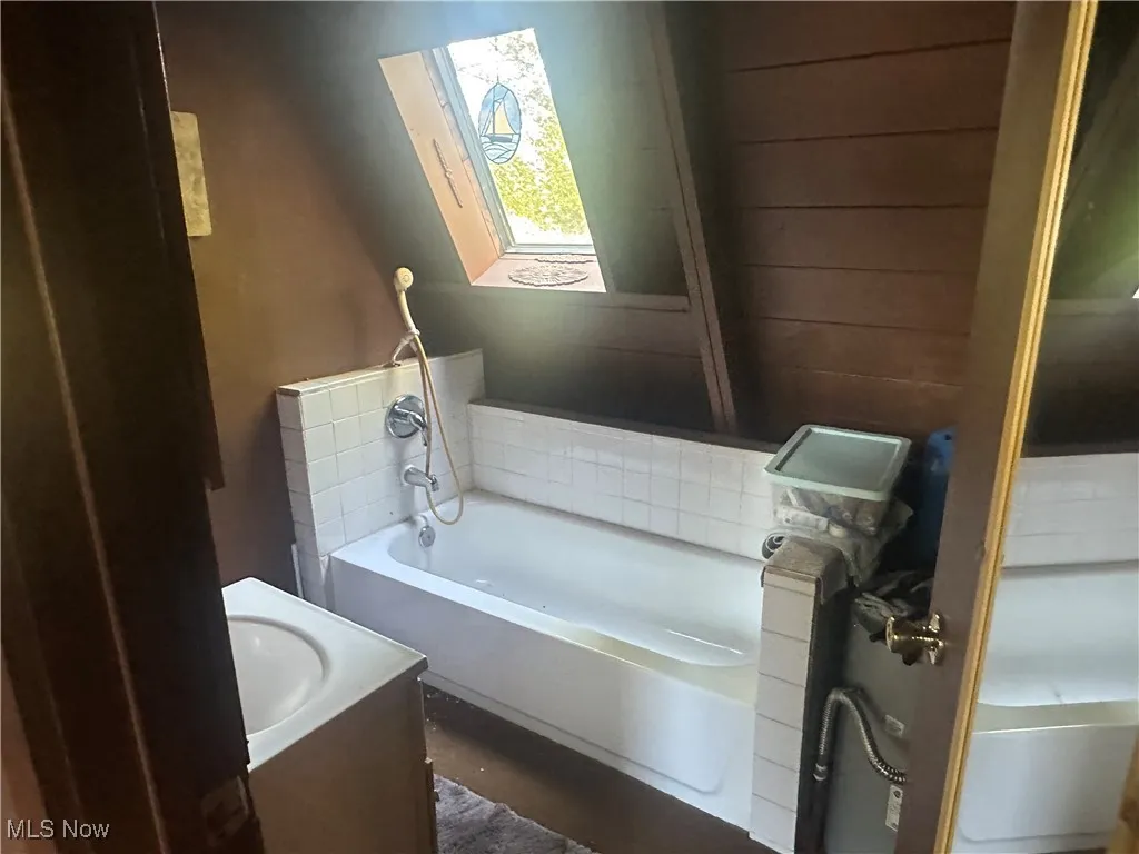 Bathroom with a bath and vanity