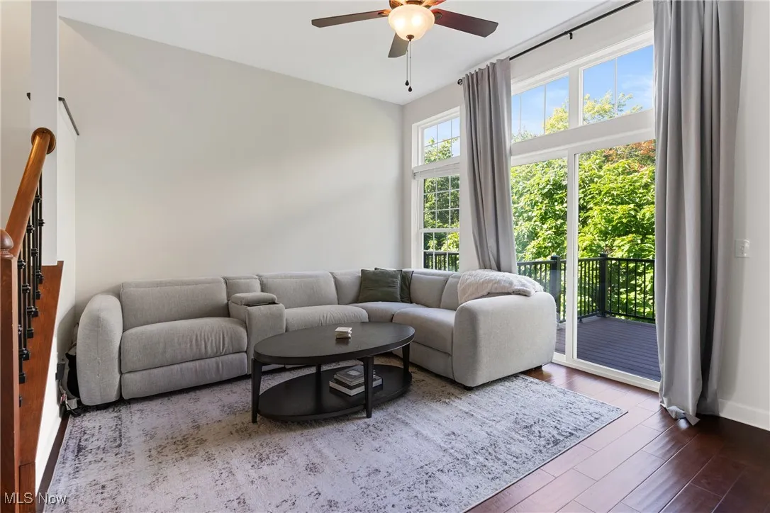 Living area with wood finished floors and a ceiling fan