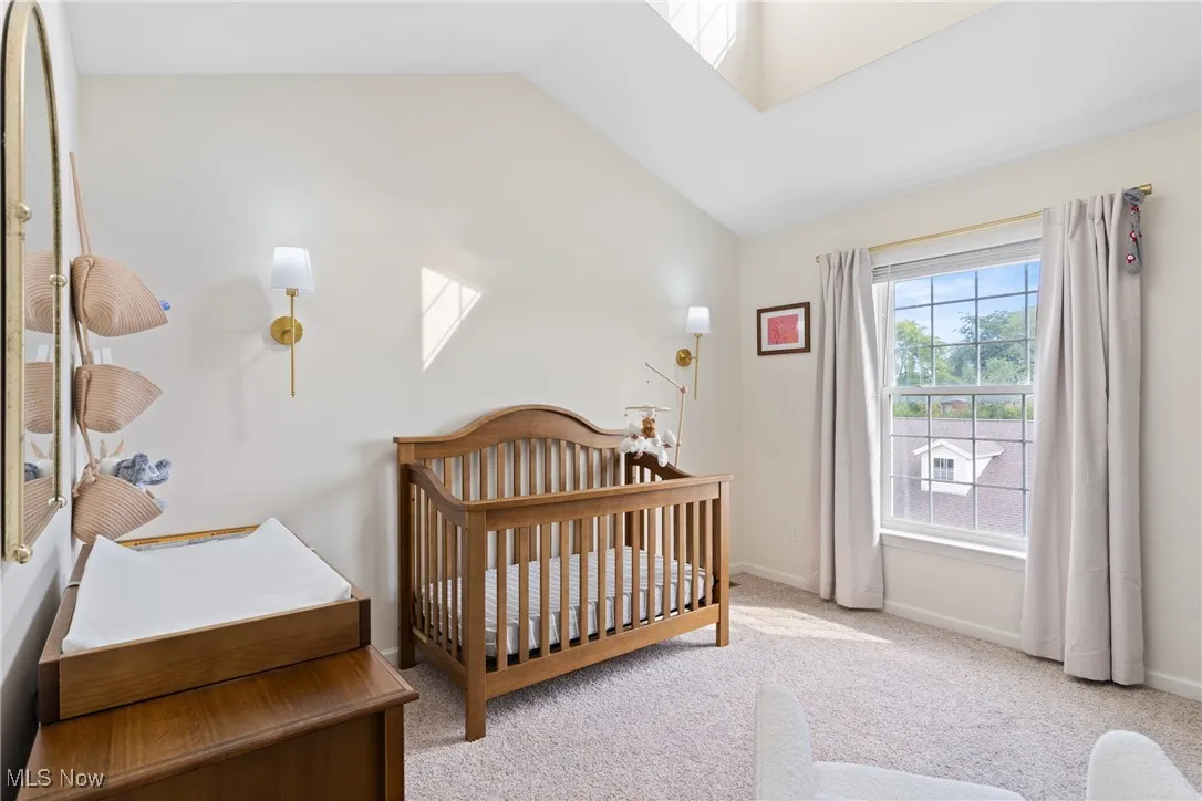 Second bedroom featuring a vaulted ceiling