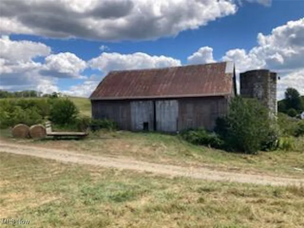 View of barn with a lawn