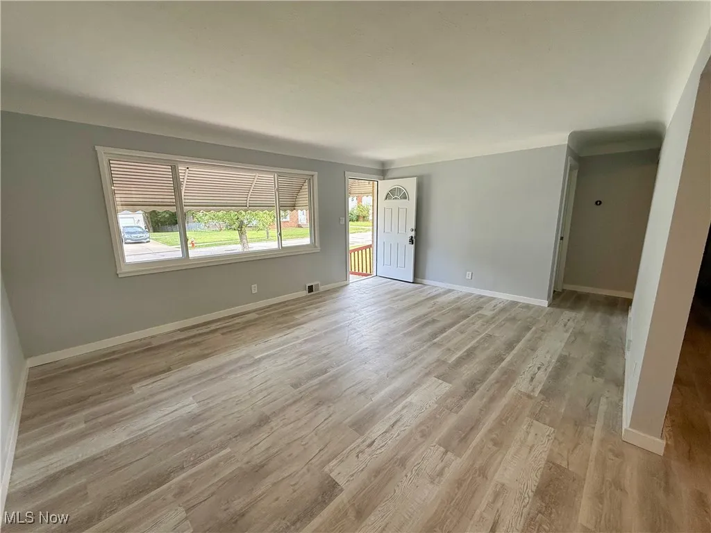 Unfurnished room with light wood-type flooring