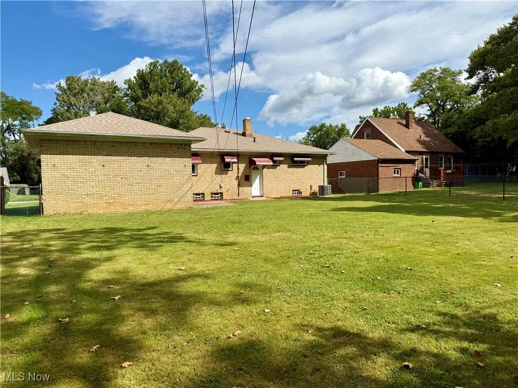 Rear view of property with brick siding