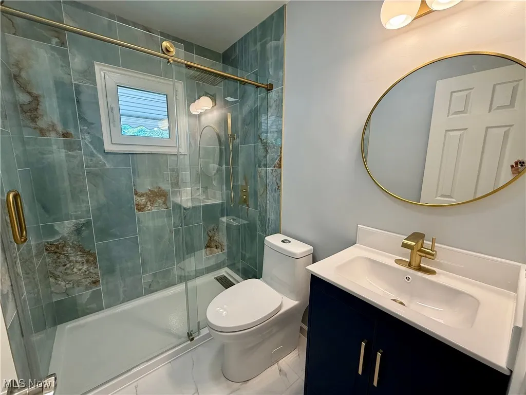 Bathroom featuring vanity and a stall shower