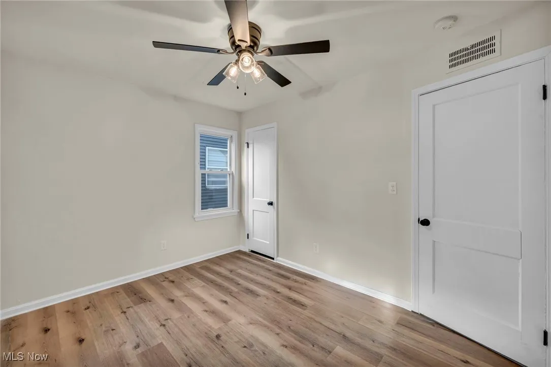 Bedroom with light wood-style floors and ceiling fan