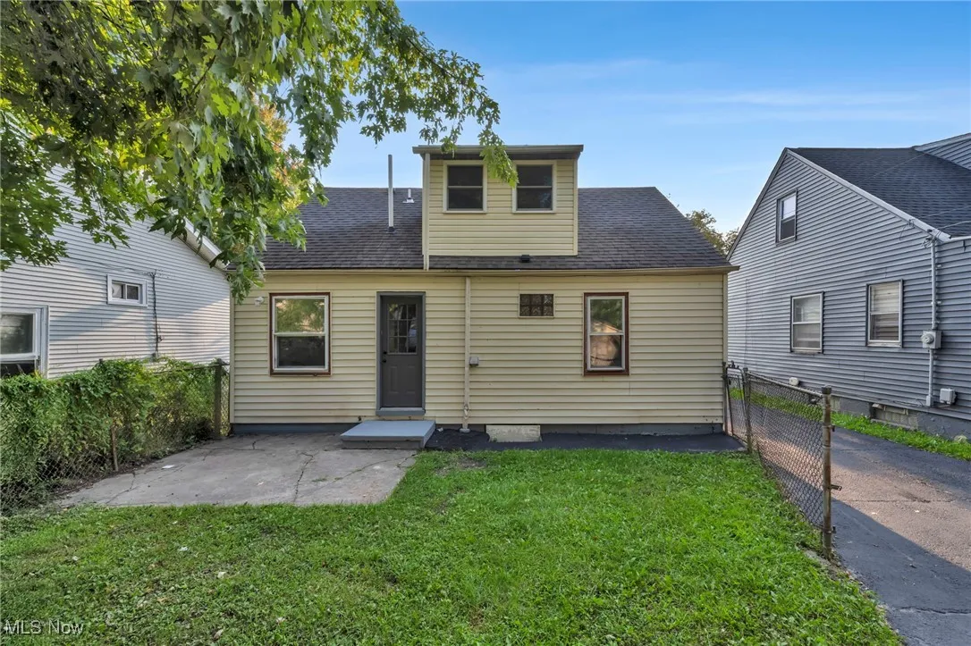 View of front of property with a patio and a shingled roof