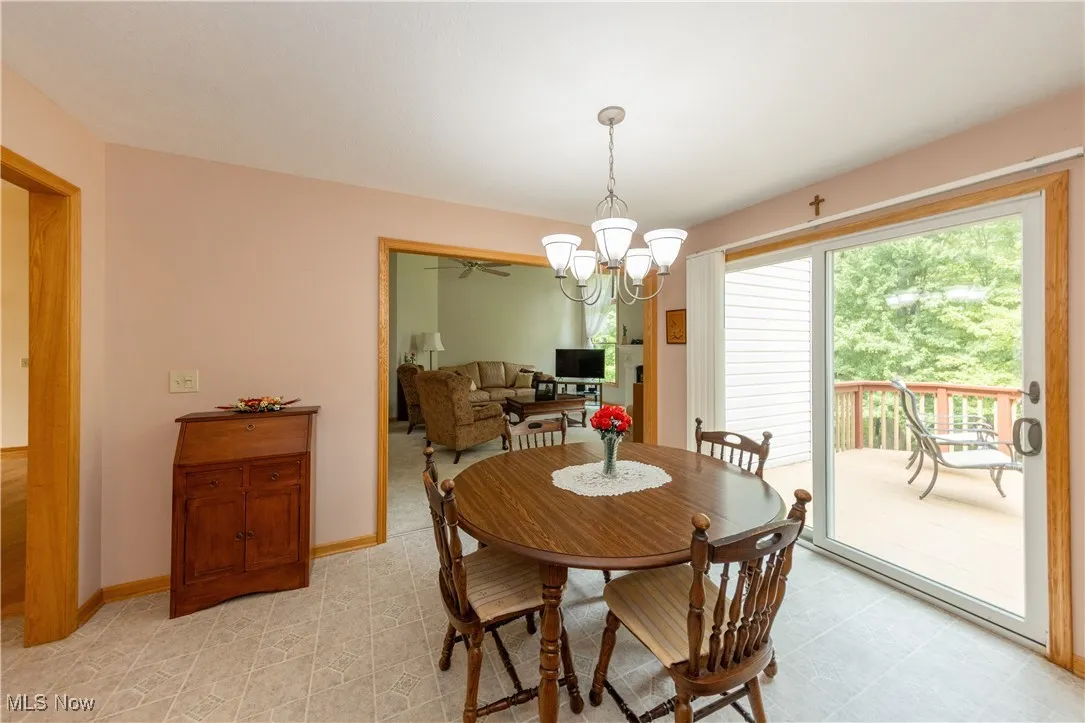 Dining space featuring a chandelier and baseboards