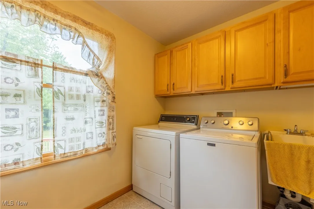 Laundry room featuring washer and dryer and cabinet space