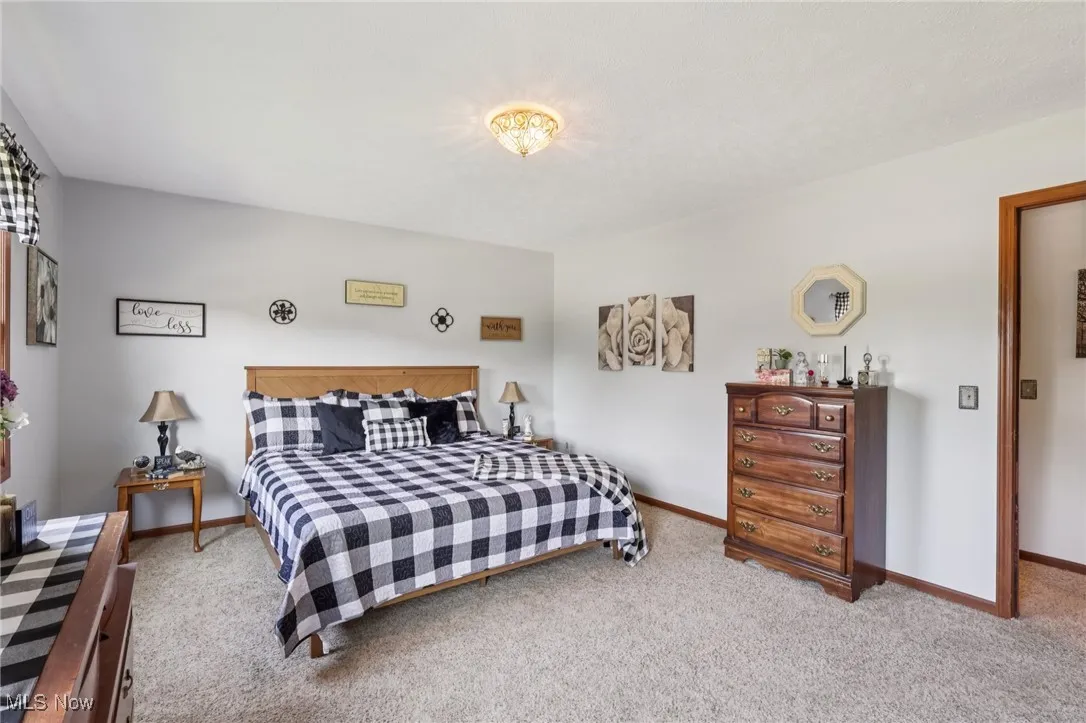 Carpeted bedroom featuring baseboards