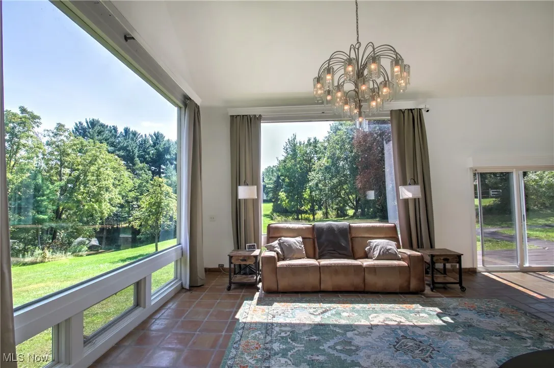 Living room featuring a chandelier and view of scattered trees