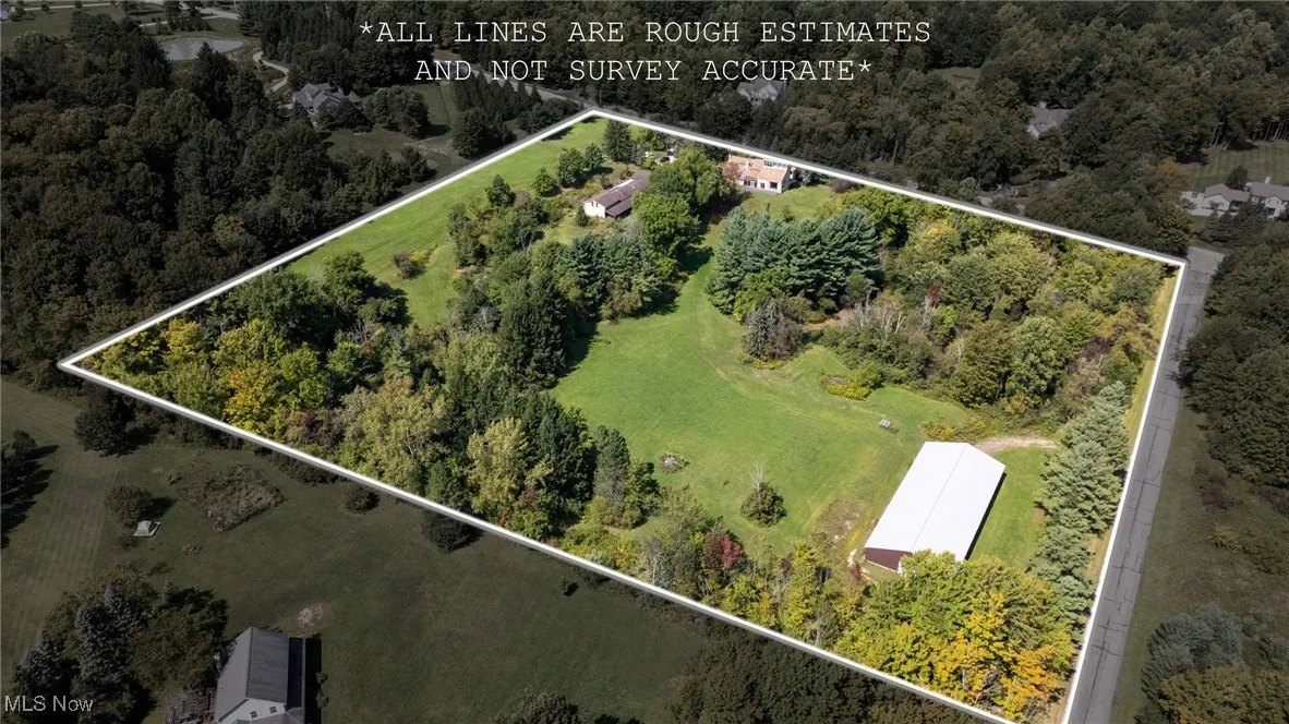 View of property location with property boundaries highlighted and a tree filled landscape