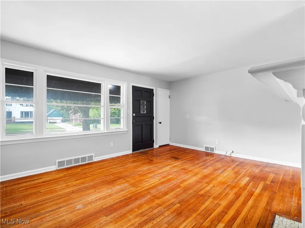 Foyer with hardwood / wood-style floors and stairs