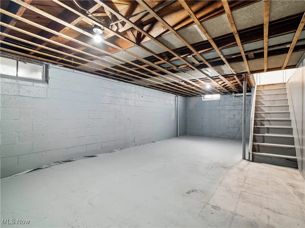 Unfinished basement featuring stairway
