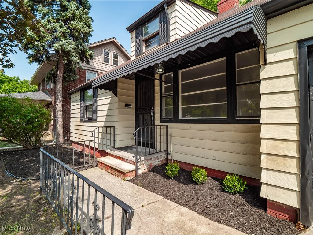 View of exterior entry with a chimney