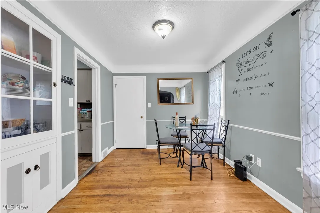 Dining room featuring light wood-style flooring and a textured ceiling