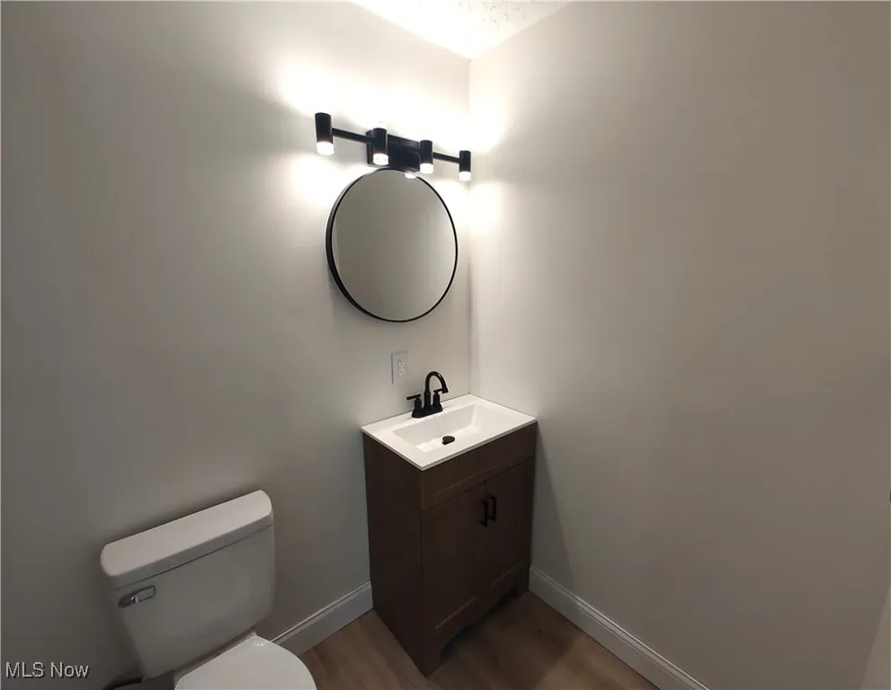 Bathroom with dark wood finished floors and vanity