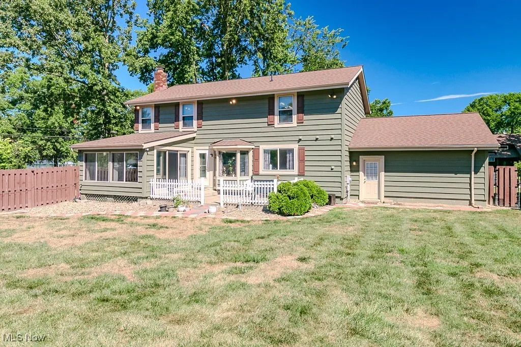 Rear view of home showing patio and fully fenced yard