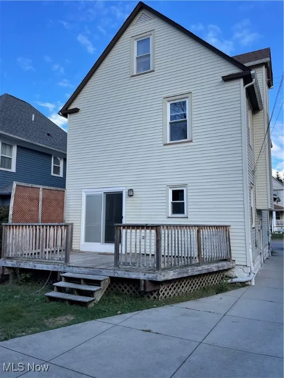 Rear view of property featuring a wooden deck