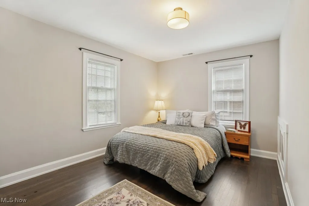 Bedroom with dark wood-style flooring