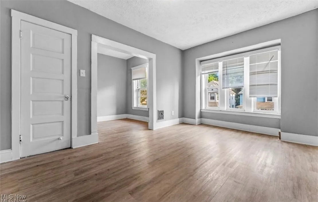 Spare room with a textured ceiling and wood finished floors