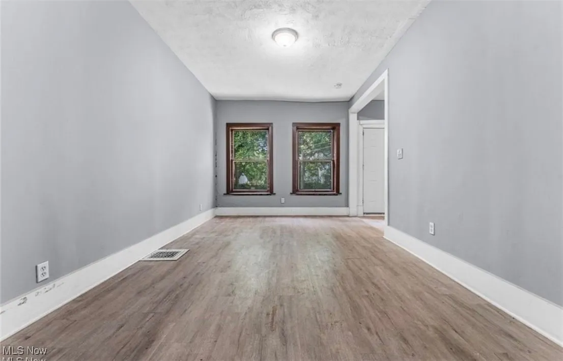 Unfurnished room featuring a textured ceiling and wood finished floors
