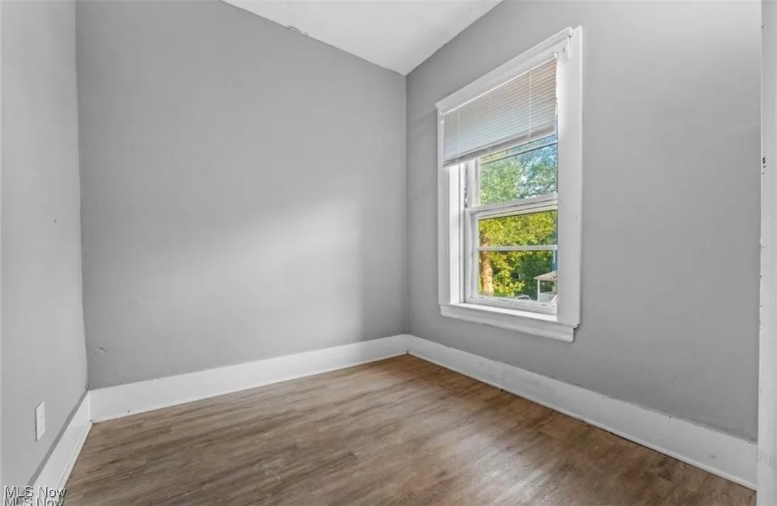Empty room featuring wood finished floors and baseboards