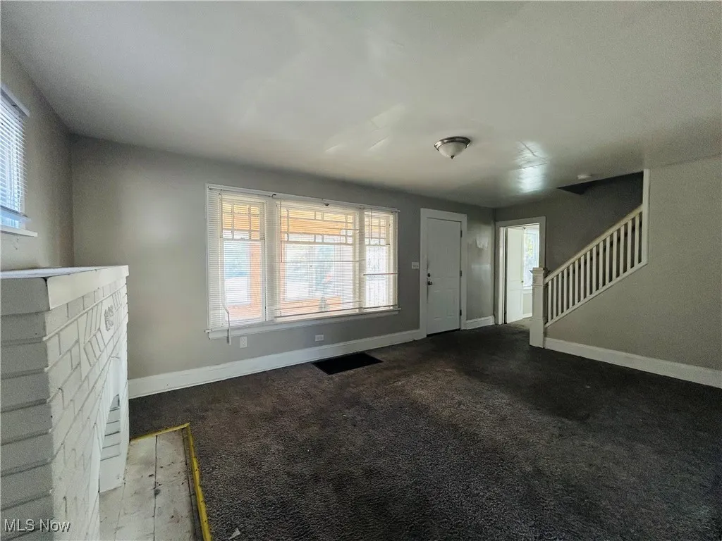 Entrance foyer featuring carpet flooring and stairway