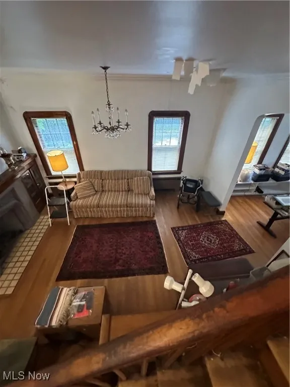 Living area with wood finished floors and a chandelier