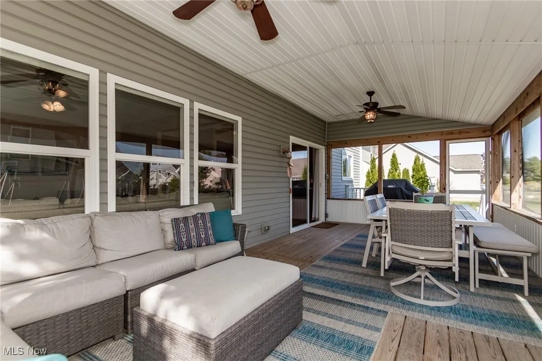 Sunroom / solarium featuring ceiling fan, outdoor dining area, vaulted ceiling, an outdoor hangout area, and a deck