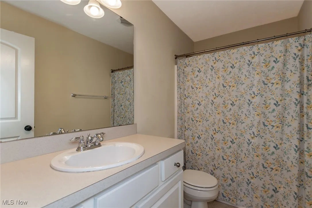 Bathroom with vanity and a shower with shower curtain