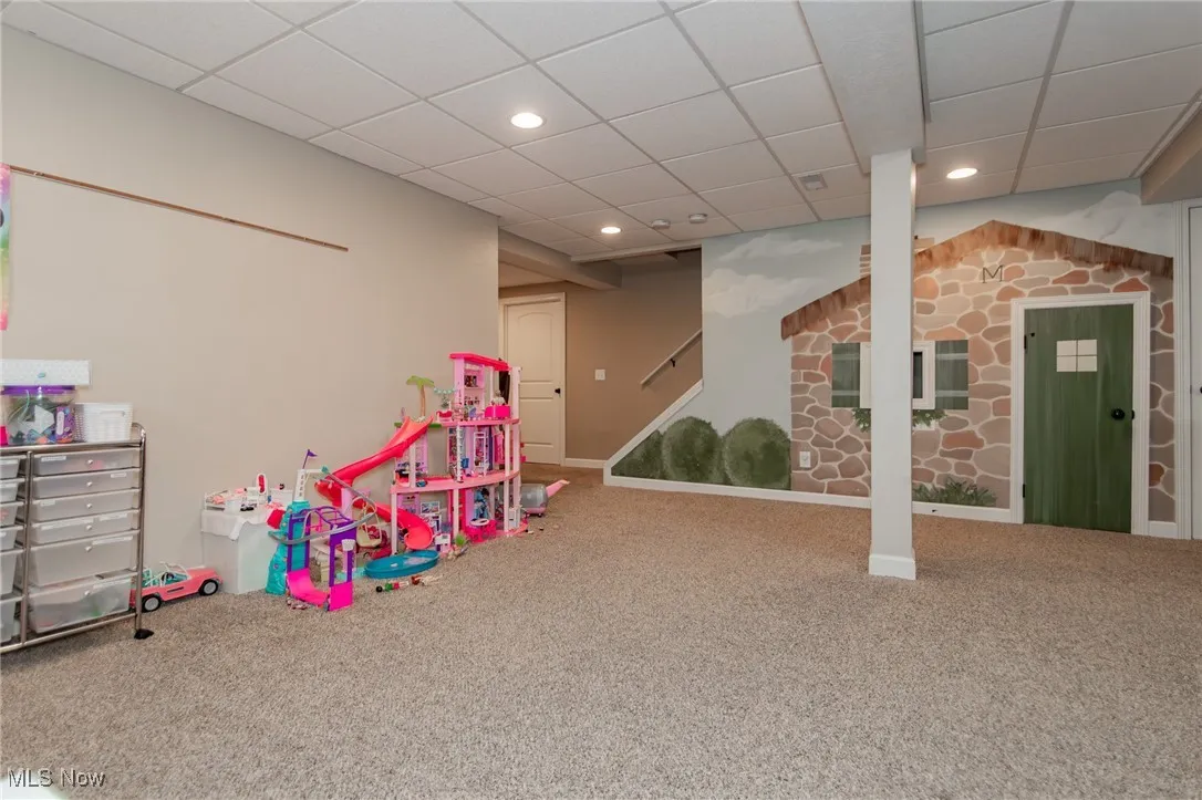 Playroom with a drop ceiling, carpet flooring, and recessed lighting