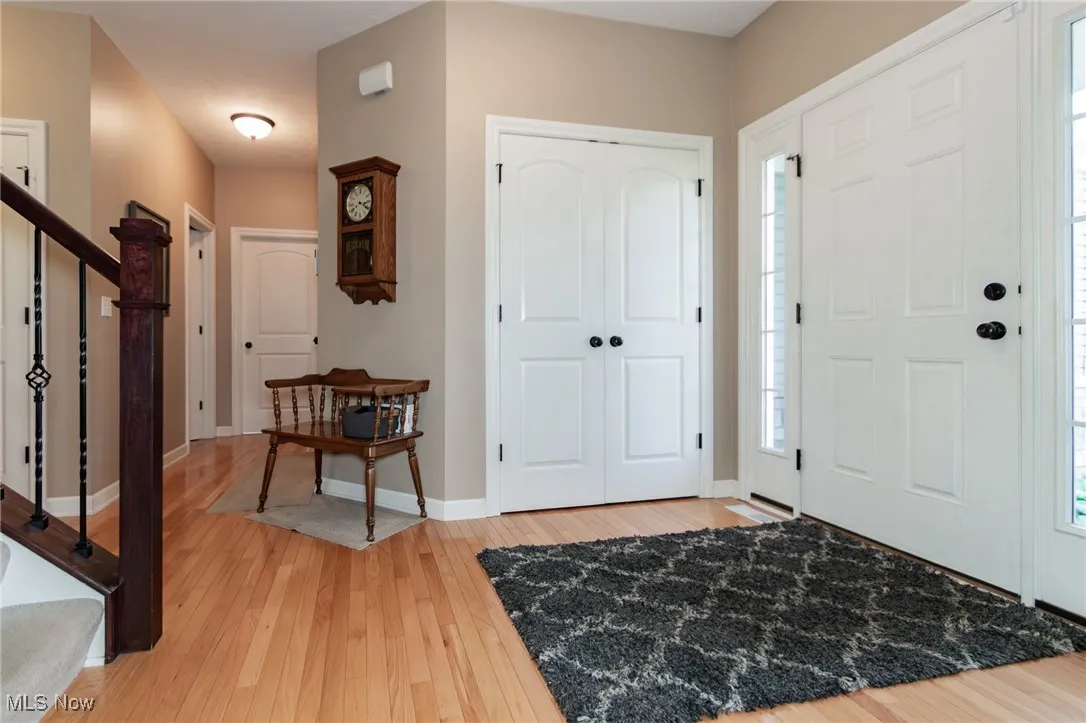 Foyer entrance with light wood-style flooring and stairway