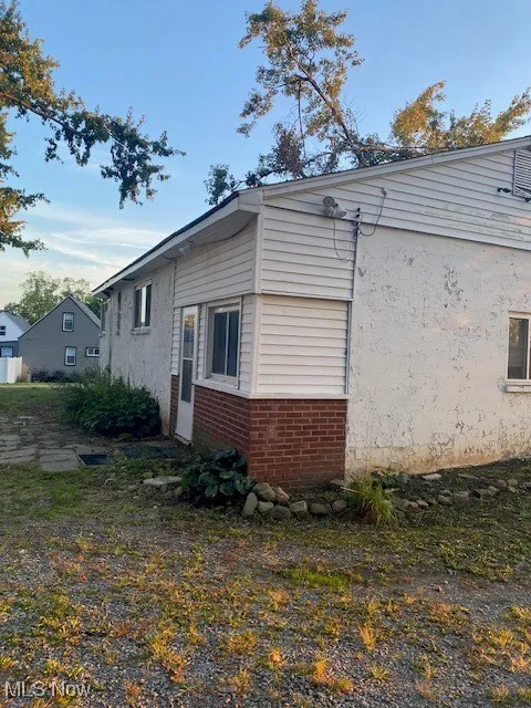 View of property exterior featuring brick siding