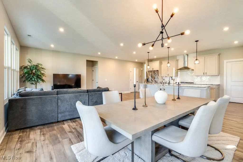 Dining area featuring light wood finished floors and recessed lighting