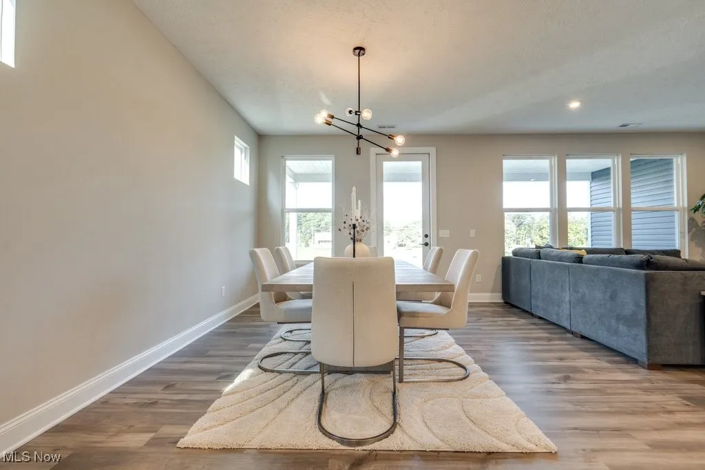 Dining space with light wood-style floors, a chandelier, and recessed lighting
